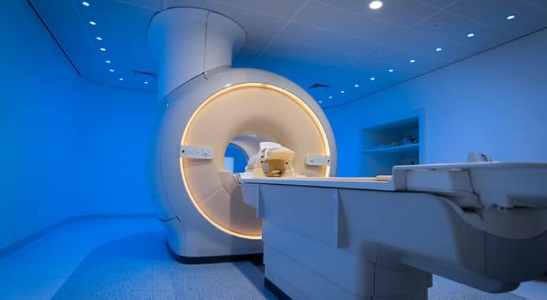 The image shows a state-of-the-art MRI machine installed in a clean lab.