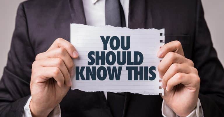 The image depicts a gentleman in a suit holding a sign that reads, "You should know this."