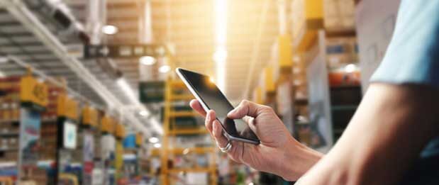 Individual on mobile phone in warehouse
