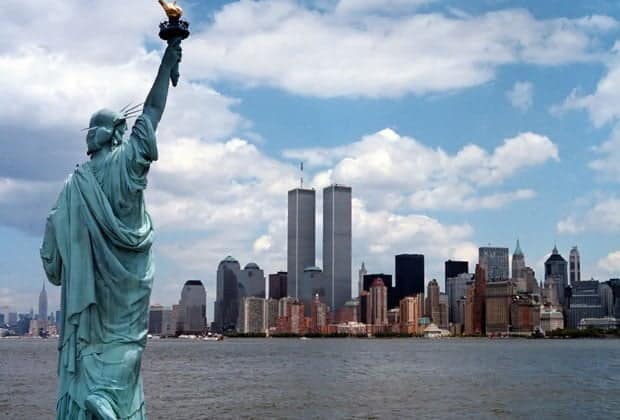 Statue of Liberty in the foreground and New York Harbor in the background.