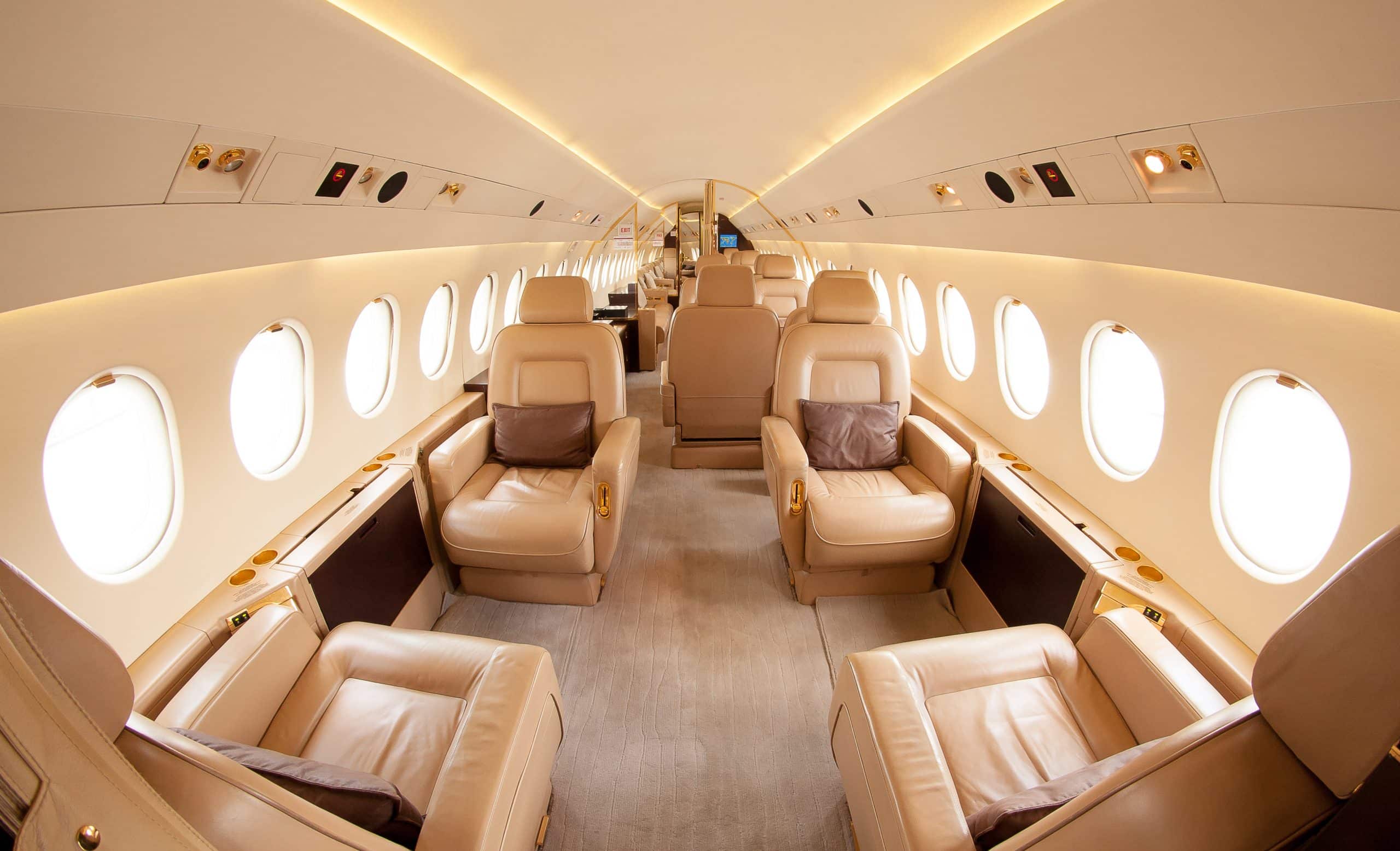 The image showcases the interior of a luxurious private jet featuring a light and elegant design.
