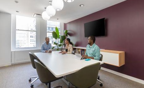 The image shows a meeting taking place at the New York Sales Office.
