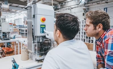Engineers men working with manufacturing equipments