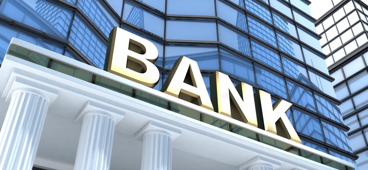 The image is a close-up view of the white-pillared entrance of a bank.