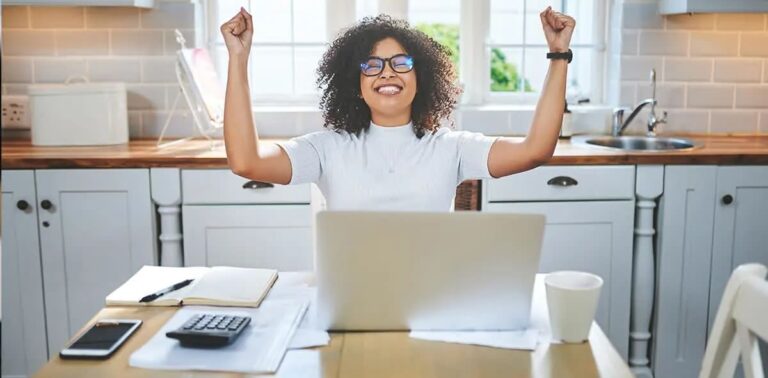 A female entrepreneur looks relieved and happy, celebrating a successful financial outcome after learning about the tax deductions for equipment leasing for her business.